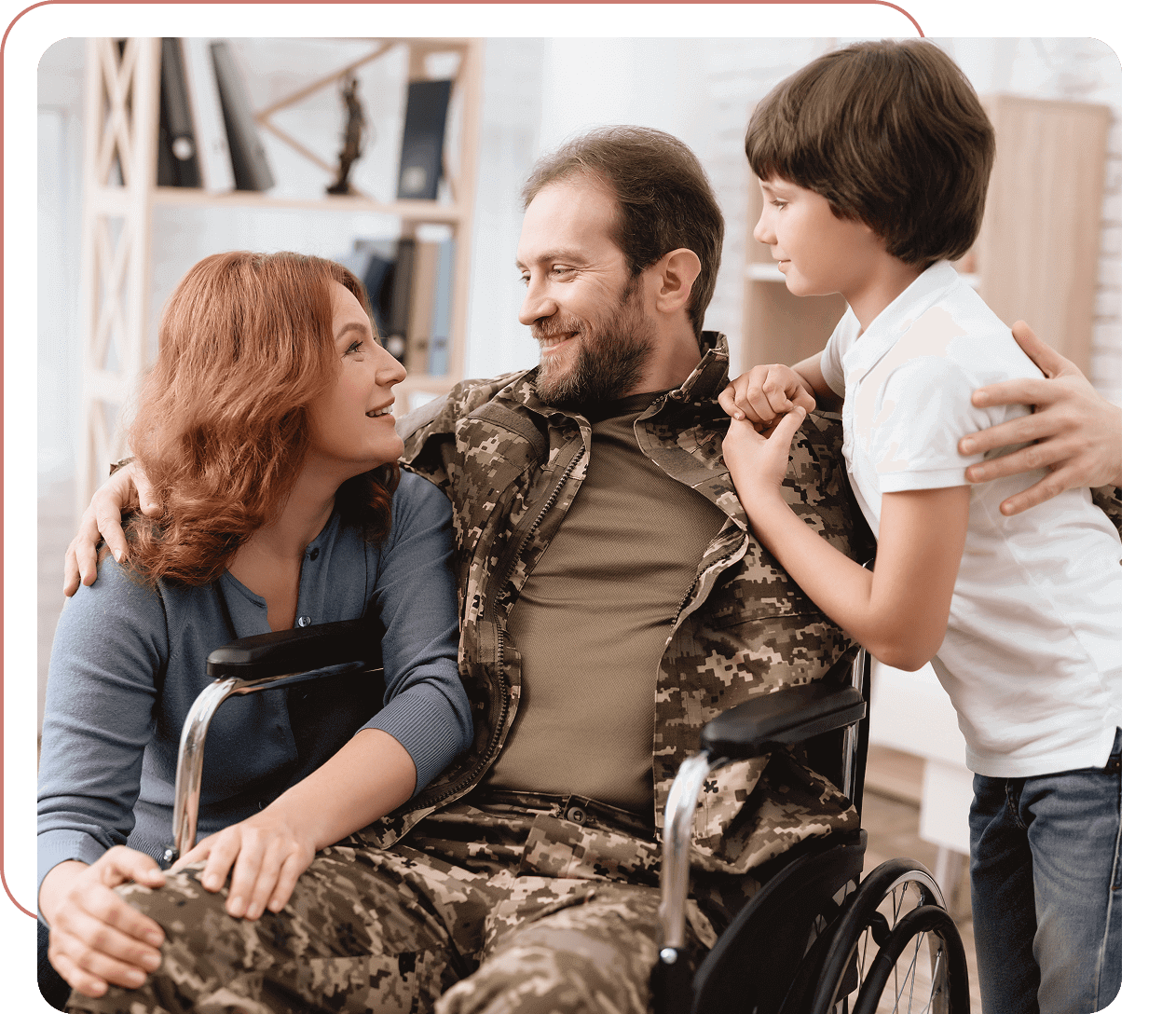 Family embraces man in military uniform wheelchair.